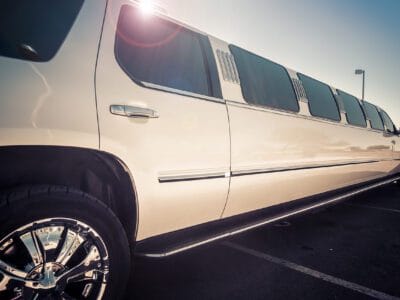 A white limo is parked in the parking lot.
